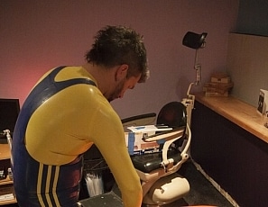 A137_MALEBONDAGE_AllPumpedUp-RickChristianAndAnotherGuy-ChristianInOrangeInflatableStudioGumBagInBasement