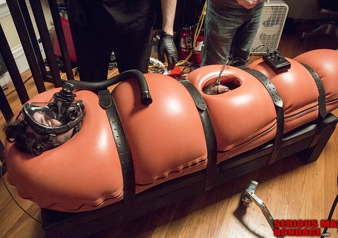 A186_MALEBONDAGE_BreatheWhileYouCan_Part3of3_ShaneDamianJames_OrangeInflatableBagLaptopAndPatientMonitor