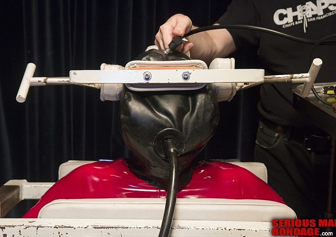 R658_MALEBONDAGE_Bubblehead_SethMichaelPunMyOdes_AcademyChairRedRubberCatsuit