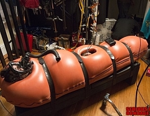 R778_MALEBONDAGE_BreatheWhileYouCan_Part1of3_ShaneDamianJames_OrangeInflatableBagLaptopAndPatientMonitor